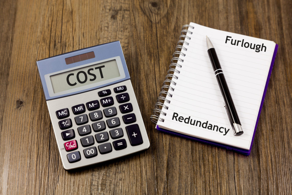 Furlough and Redundancy Concept - with calculator and the word 'cost'